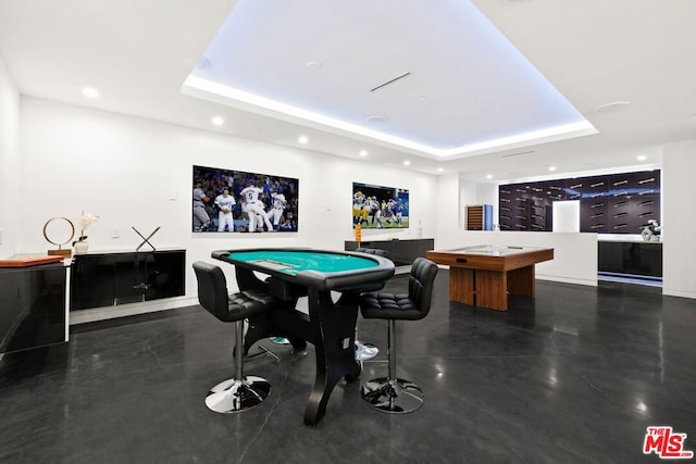 game room featuring a raised ceiling