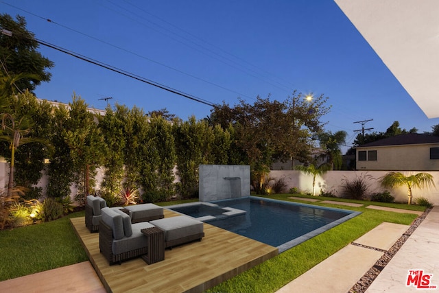 view of pool with a yard and a jacuzzi