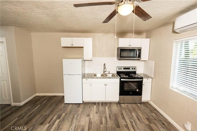 kitchen featuring white cabinetry, appliances with stainless steel finishes, sink, and a wall mounted AC