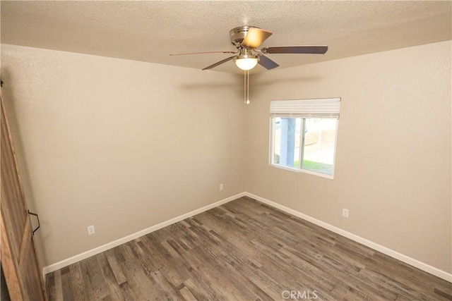 spare room with ceiling fan, dark hardwood / wood-style floors, and a textured ceiling