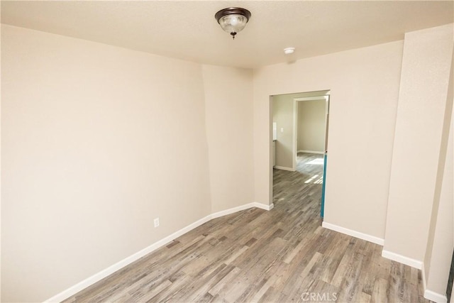 unfurnished room with hardwood / wood-style floors