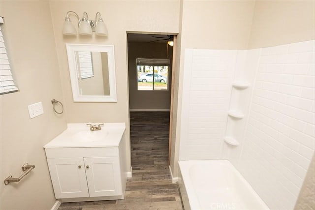 bathroom with vanity, hardwood / wood-style floors, and bathing tub / shower combination