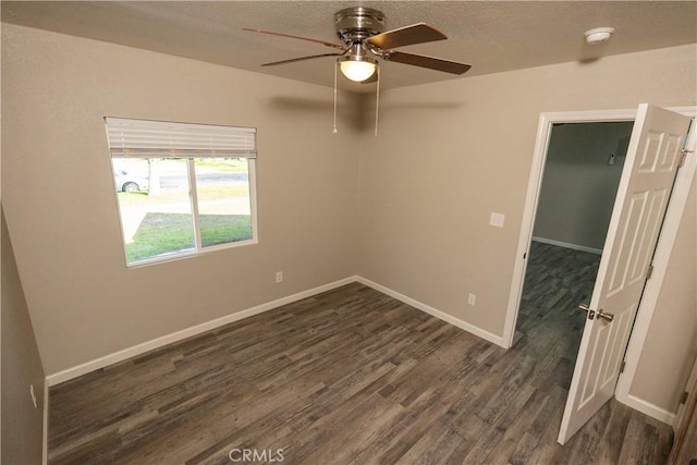 unfurnished room with dark hardwood / wood-style flooring, a textured ceiling, and ceiling fan