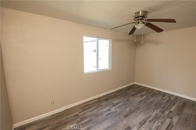 spare room with dark hardwood / wood-style flooring