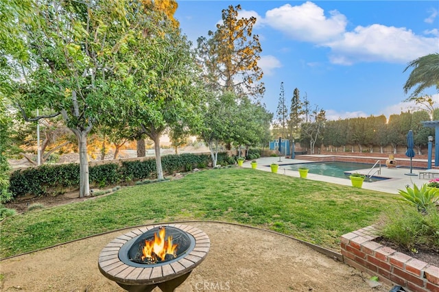 view of yard with a fire pit