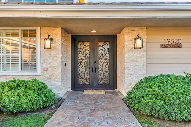 view of exterior entry featuring french doors