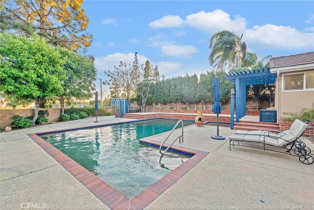 view of swimming pool featuring a pergola and a patio