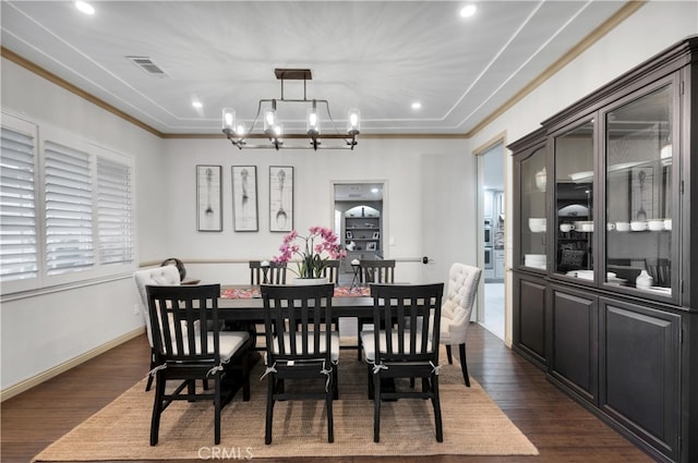 dining space featuring an inviting chandelier and dark hardwood / wood-style flooring