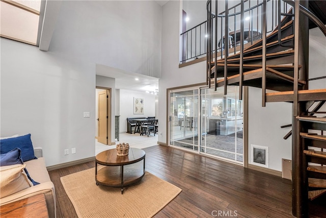 living room featuring hardwood / wood-style floors and a towering ceiling