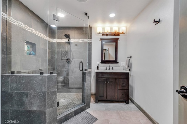 bathroom featuring vanity, toilet, and an enclosed shower