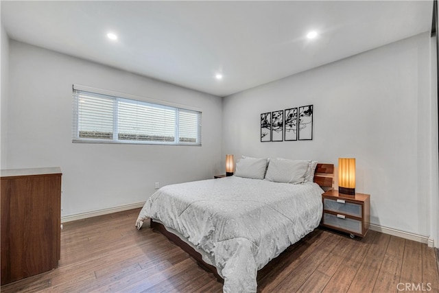 bedroom with dark wood-type flooring