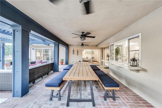 view of patio / terrace featuring ceiling fan and an outdoor living space