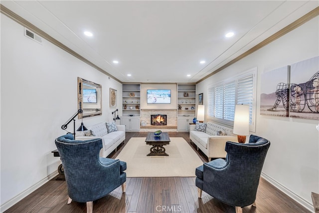 living room featuring built in shelves, wood-type flooring, and ornamental molding