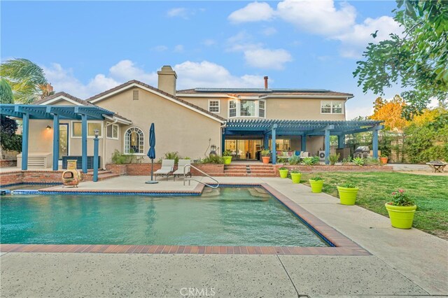 back of house featuring a patio area and a pergola