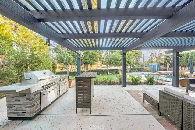 view of patio featuring exterior kitchen, a swimming pool, area for grilling, and a pergola