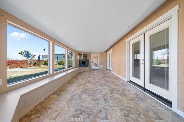 unfurnished sunroom featuring french doors