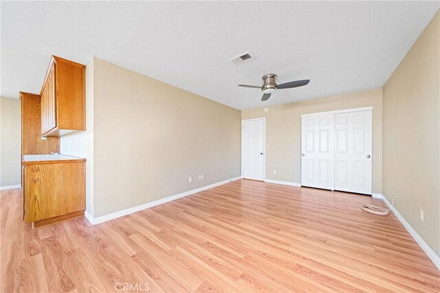 unfurnished bedroom with ceiling fan and light hardwood / wood-style flooring