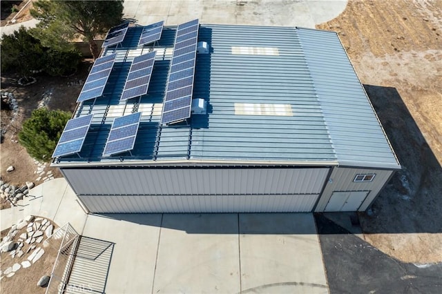 view of side of home with solar panels