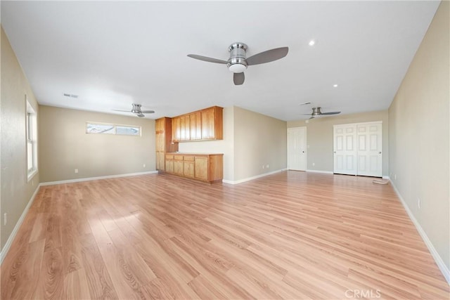 unfurnished living room with ceiling fan and light hardwood / wood-style floors