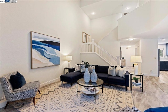 living room featuring a towering ceiling