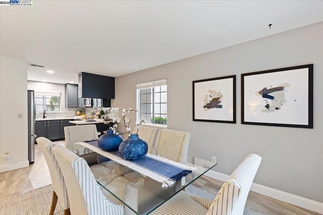 dining area featuring light hardwood / wood-style flooring and a wealth of natural light