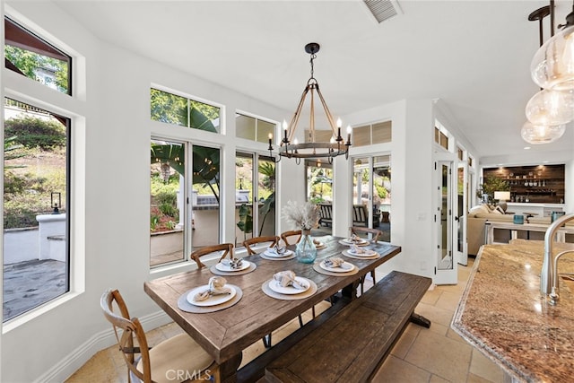 dining space with a healthy amount of sunlight and a chandelier