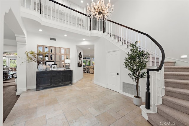 entrance foyer featuring an inviting chandelier and a towering ceiling