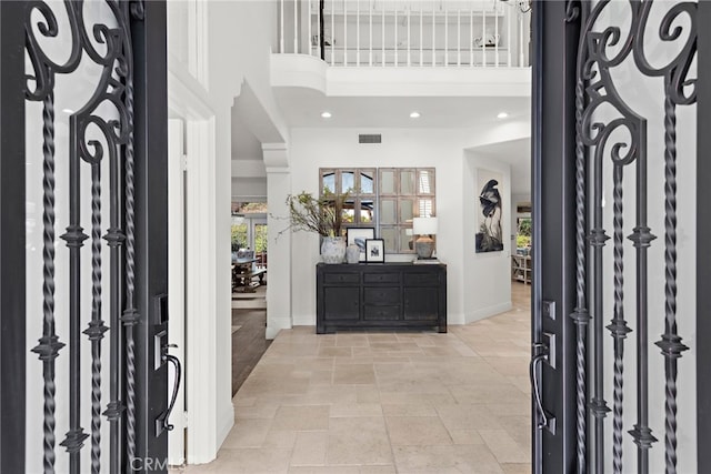 entrance foyer featuring a towering ceiling