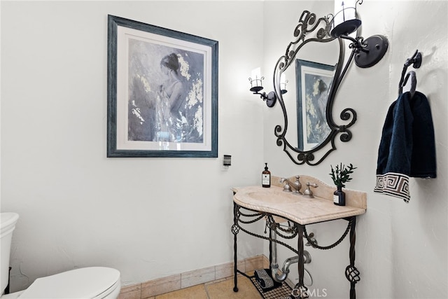 bathroom featuring toilet and tile patterned flooring