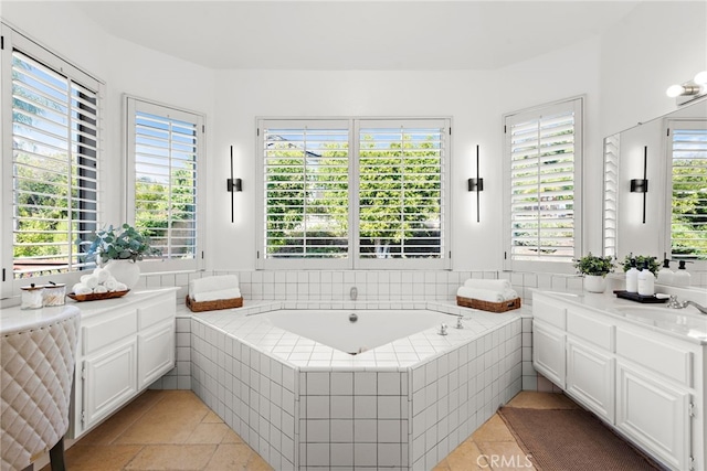 bathroom featuring vanity, plenty of natural light, and tiled bath