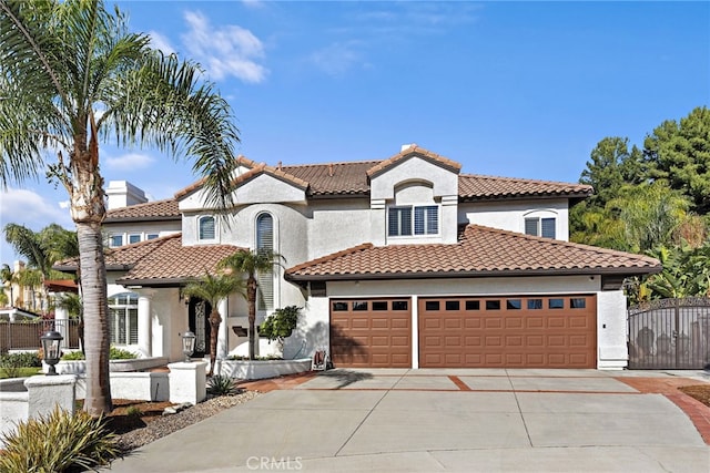 mediterranean / spanish home with a garage