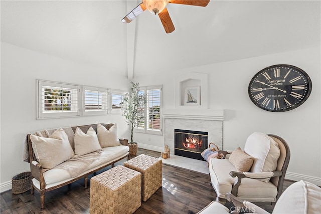 living room featuring ceiling fan, a high end fireplace, dark hardwood / wood-style floors, and lofted ceiling with beams