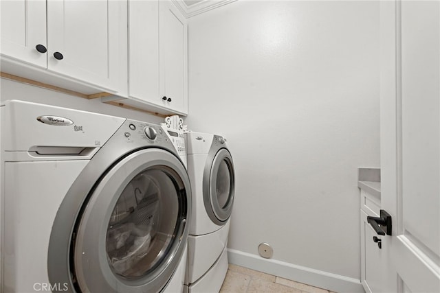 washroom with cabinets, independent washer and dryer, and light tile patterned floors