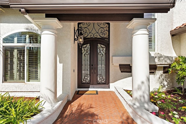 view of exterior entry featuring french doors