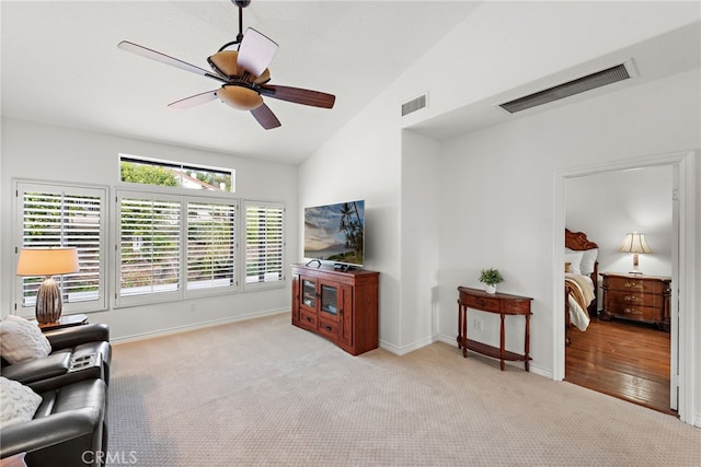 carpeted living room featuring vaulted ceiling and ceiling fan