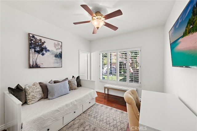 living room featuring hardwood / wood-style flooring and ceiling fan