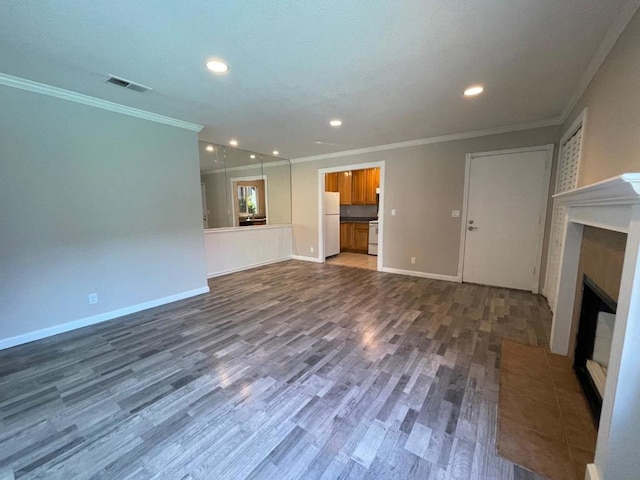 unfurnished living room with ornamental molding and dark hardwood / wood-style floors