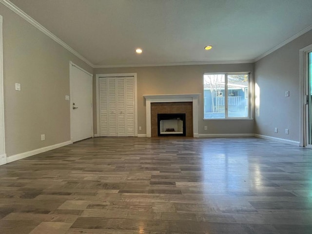 unfurnished living room featuring ornamental molding and dark hardwood / wood-style floors