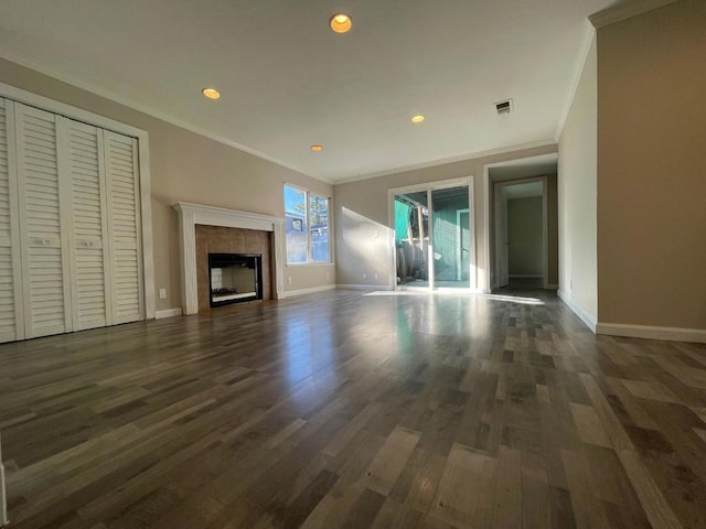 unfurnished living room with a fireplace, crown molding, and dark wood-type flooring