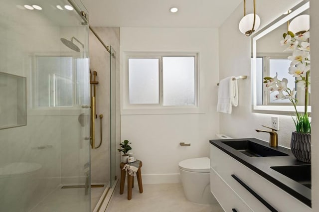 bathroom featuring vanity, toilet, and walk in shower