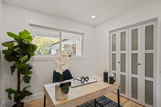 office area with light hardwood / wood-style floors