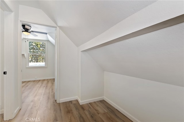 additional living space featuring lofted ceiling and hardwood / wood-style floors