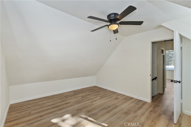 bonus room featuring vaulted ceiling and light wood-type flooring