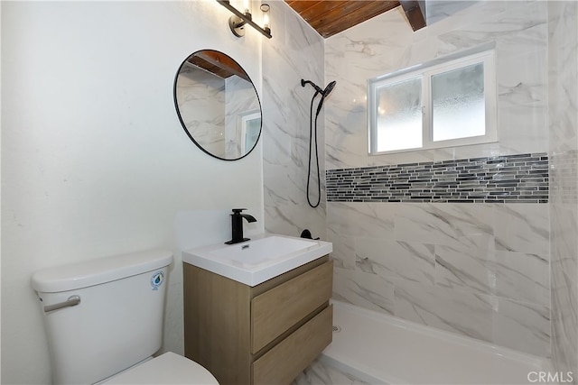 bathroom featuring vanity, toilet, and tiled shower