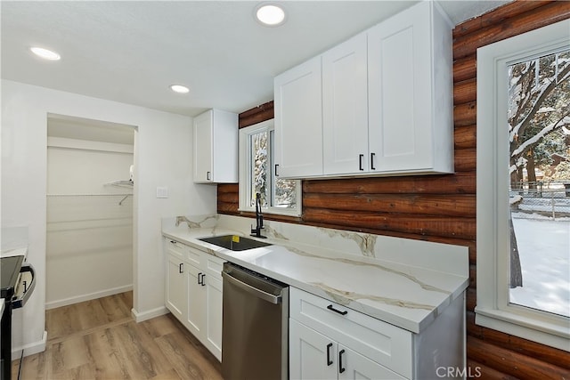 kitchen with white cabinetry, stainless steel dishwasher, and light stone counters