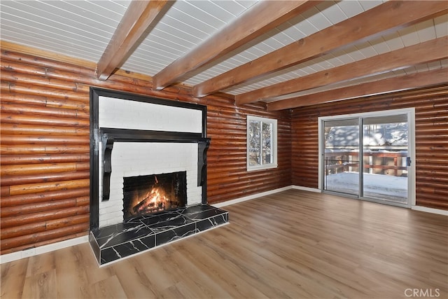 unfurnished living room with hardwood / wood-style flooring, a fireplace, and beamed ceiling