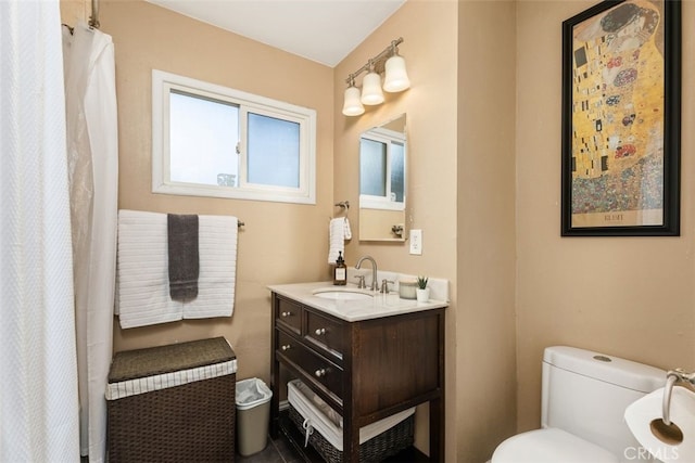 bathroom with vanity, toilet, and walk in shower