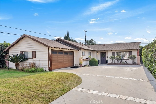 ranch-style house featuring a garage and a front yard