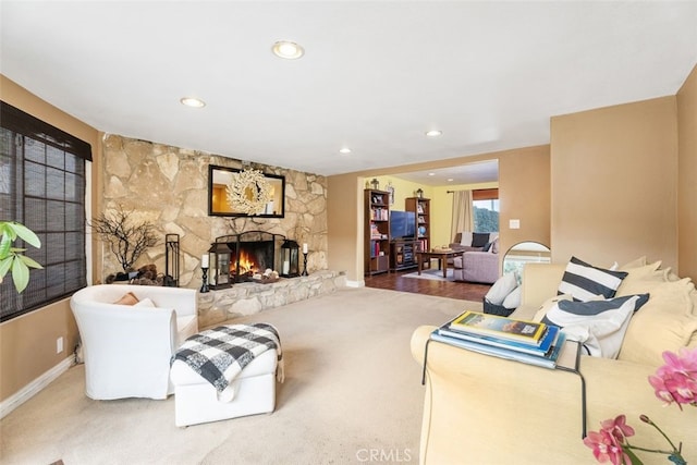 carpeted living room with a fireplace