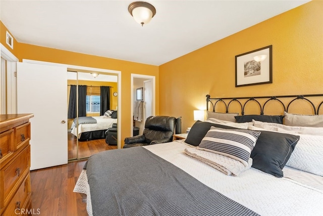 bedroom featuring dark hardwood / wood-style floors and a closet